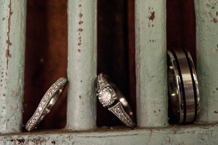 Close up of a diamond ring and wedding bands