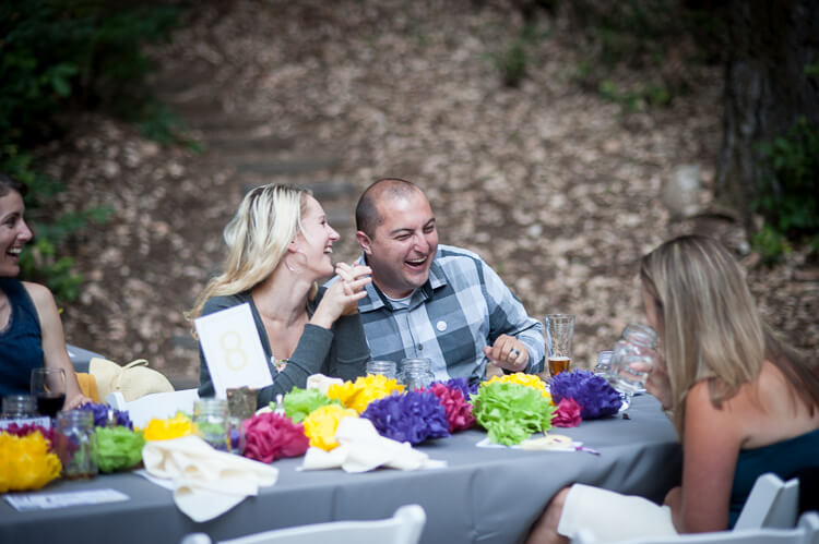 A couple laughing and sitting at a table