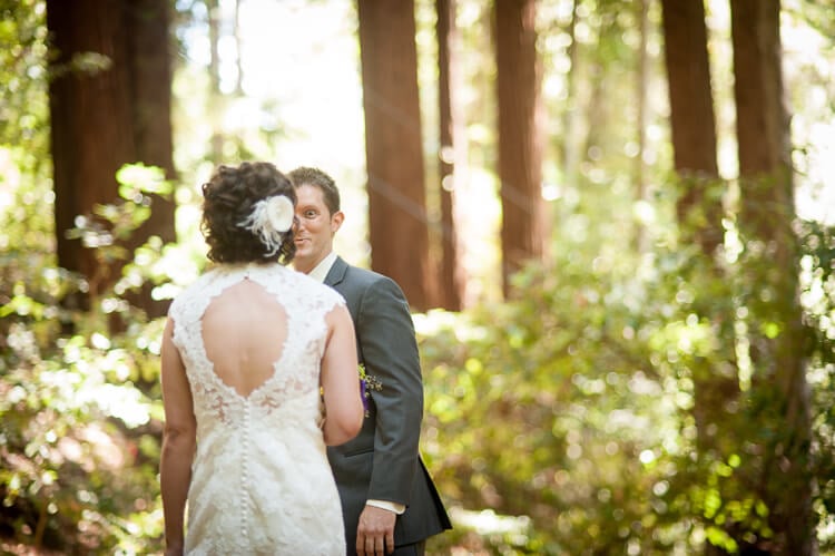 A groom and a bride standing among trees