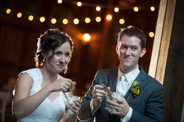 A bride and a groom eating a dessert