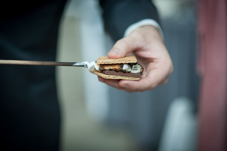 Close up of a man holding a s\'more