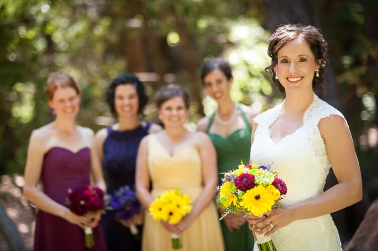 A bride and her bridesmaids posing for the camera