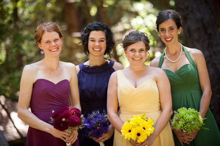 A group of women holding bouquets and posing for the camera