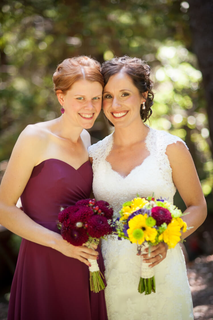 A bride and a bridesmaid posing for the camera
