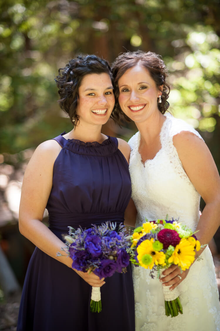 A bride and a bridesmaid posing for the camera