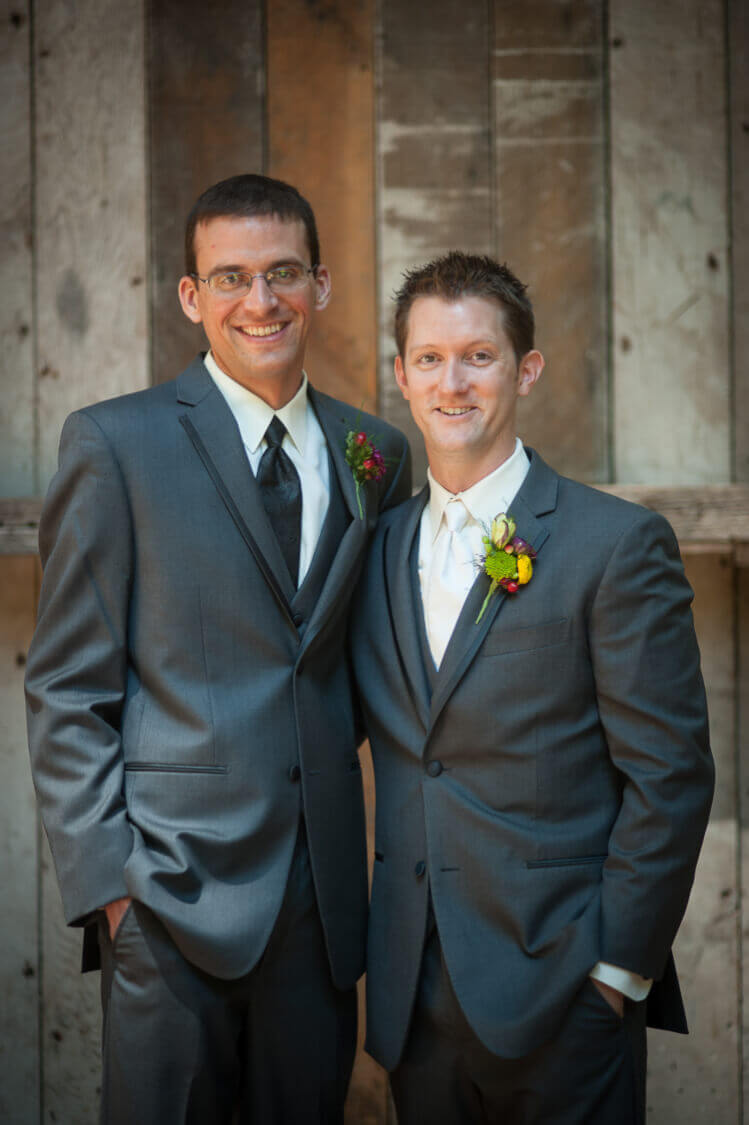 A groom and one of his groomsmen posing for the camera