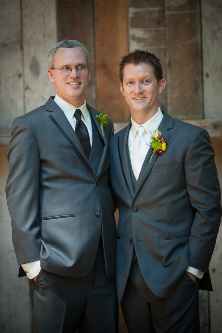 A groom and one of his groomsmen posing for the camera