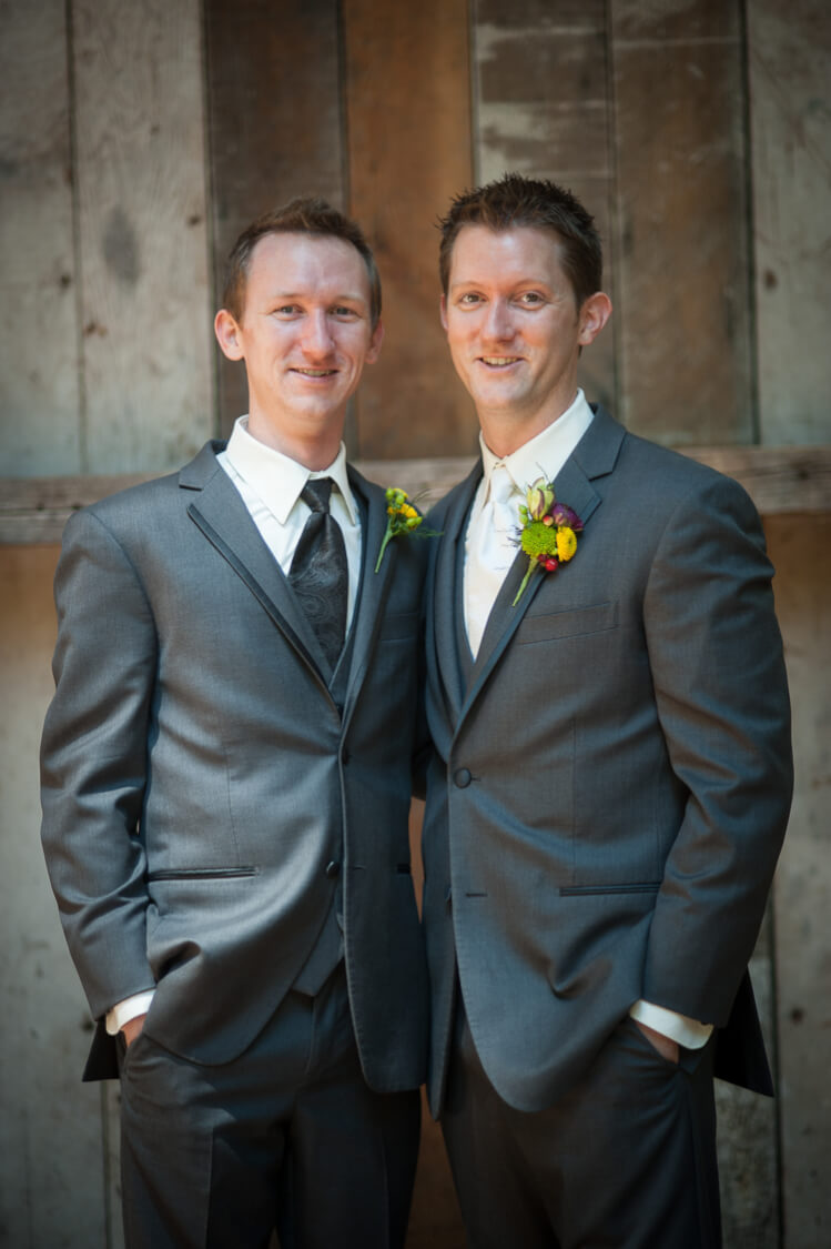 A groom and one of his groomsmen posing for the camera