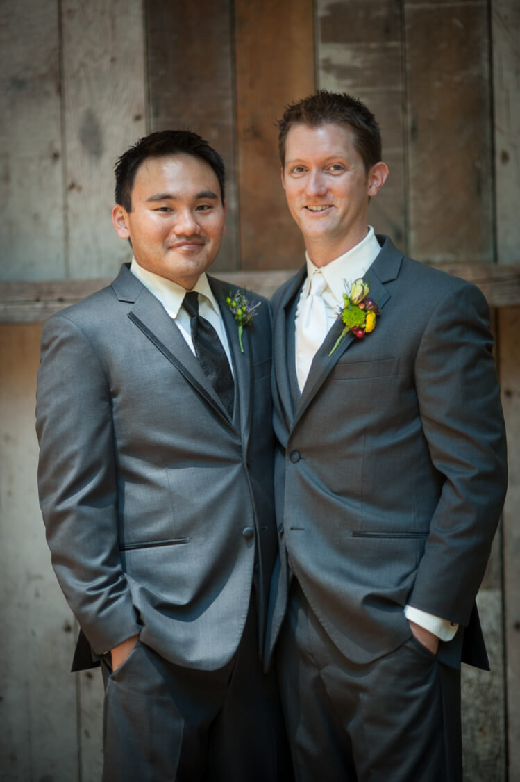 A groom and one of his groomsmen posing for the camera
