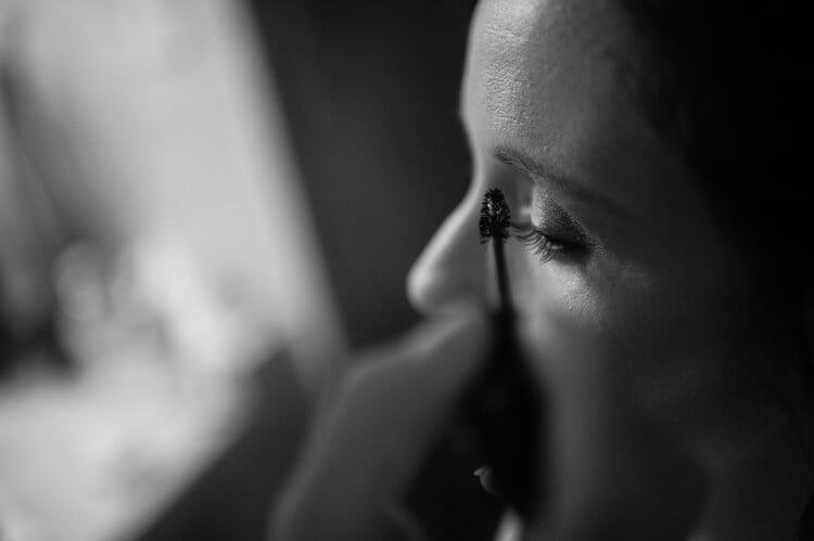 A close up of a woman having mascara applied