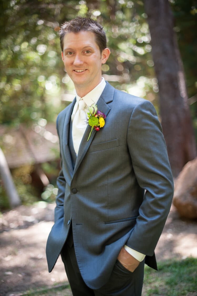 A groom smiling at the camera