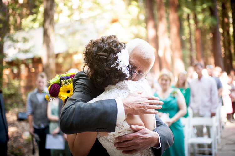Bride and her father hugging one another