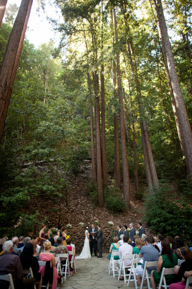 A bride and groom getting married in the woods