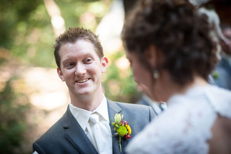 A groom smiling at his bride