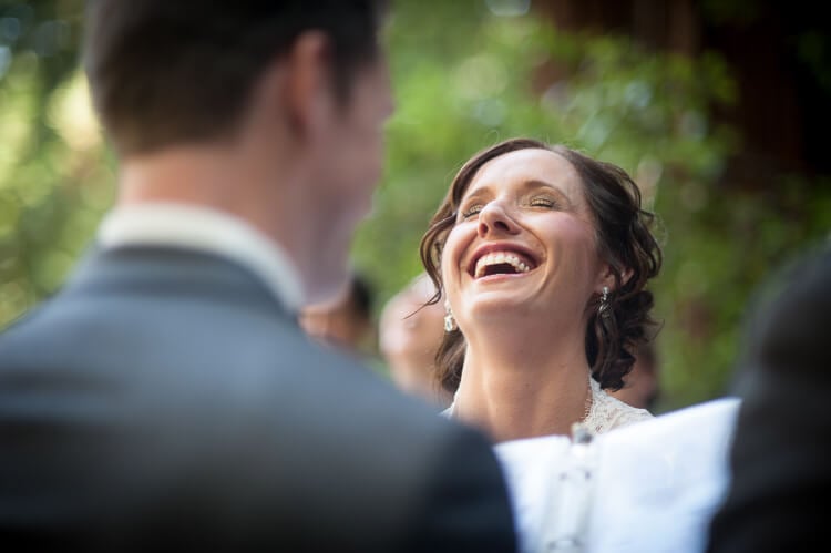 A bride laughing next to her groom
