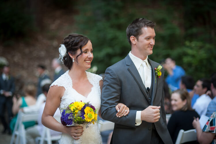 A bride and groom walking down the aisle