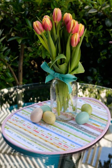 Sew a sweet Easter table topper in the shape of an Easter egg, using up your leftover selvages! A great scrapbuster sewing project.