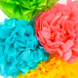 A close up of four paper cut flowers, in blue, green, yellow and pink