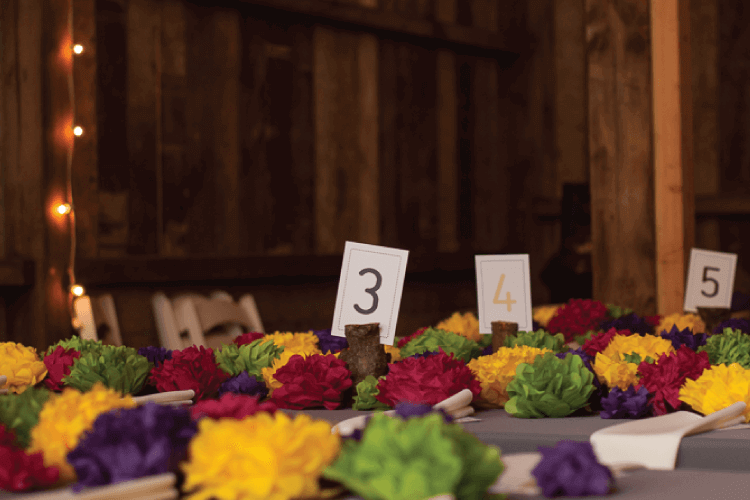 finished paper tissue flowers at tables at wedding