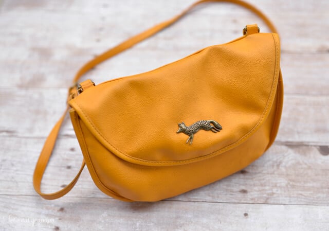 small woman's handbag on a wooden background