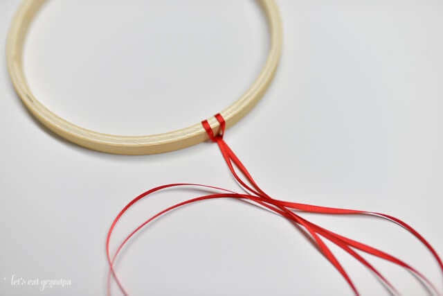patriotic windsock tutorial - embroidery hoop with red ribbon attached to it