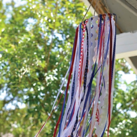 Use ribbon and other scraps to make this patriotic windsock! It's the perfect outdoor decor for the 4th of July and Memorial Day. A great scrapbusting project!