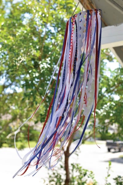 A red, white and blue windsock hanging from the eves of a building