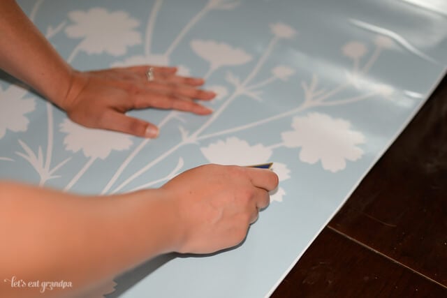 hands adding floral decals