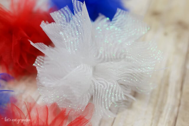 closeup of red, white, and blue firework poofs from tulle