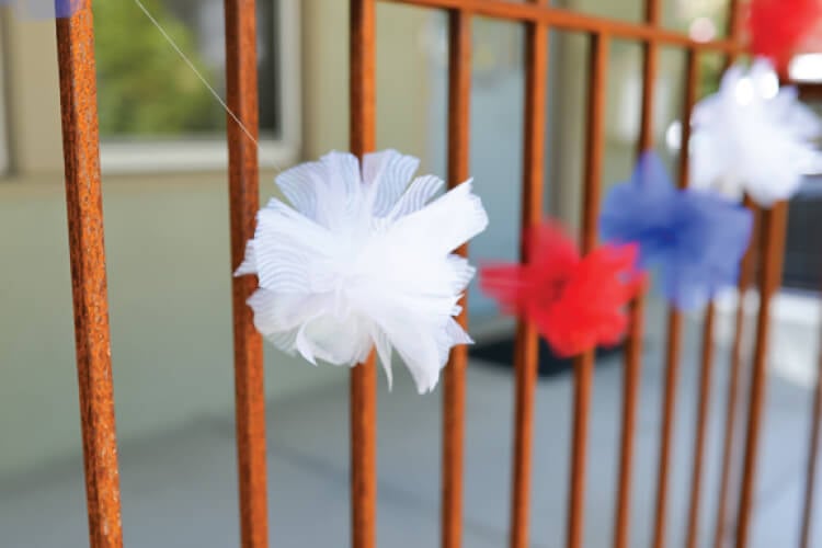 DIY tulle fireworks strung across gate 