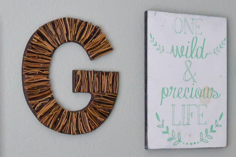 G initial and wall art hung on wall