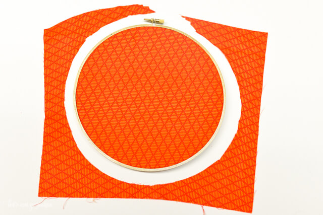 orange fabric covering embroidery hoop