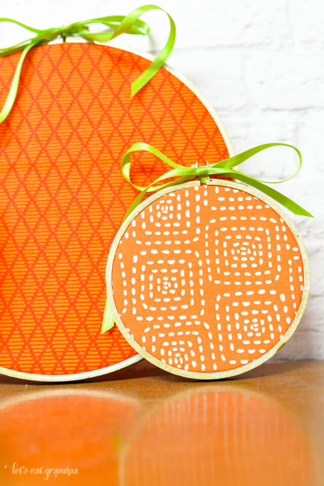 close up of two orange pumpkin embroidery hoops finished