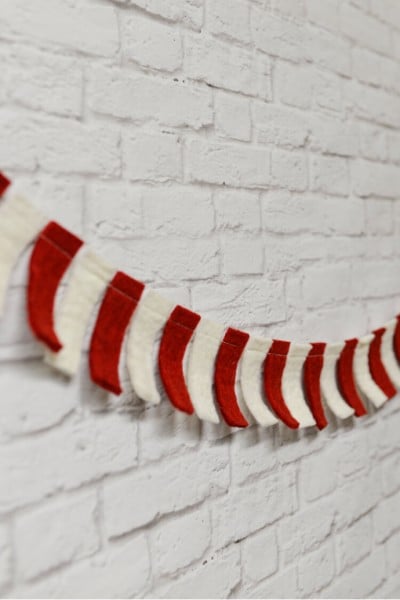 A red and white banner hanging on a white brick wall