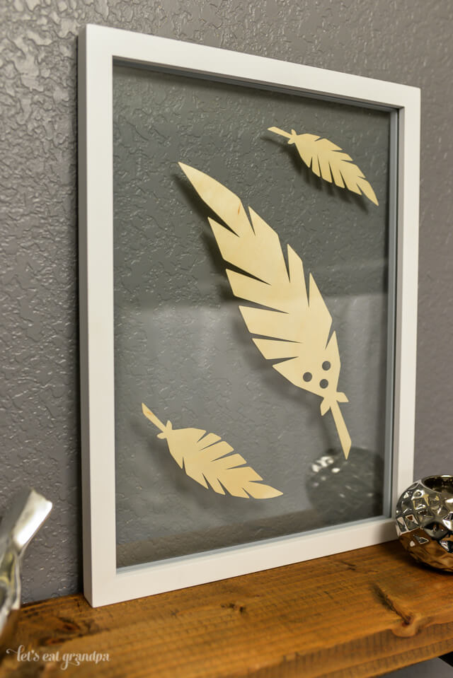 feather floating artwork in bathroom