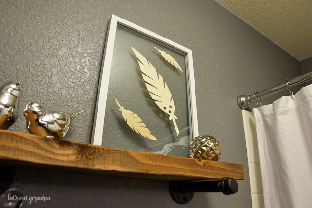 feather floating artwork in bathroom