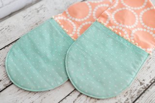 Two handed potholder lying of a wooden table