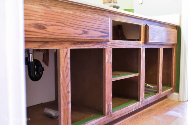 brown cabinets with drawers and doors taken off