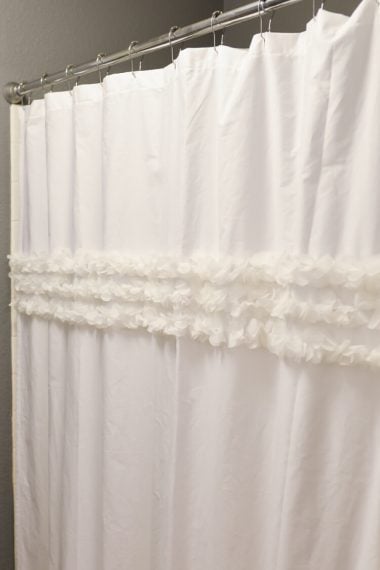 How to make a custom shower curtain using a flat sheet and an old shower curtain as a template -- then embellish as desired!