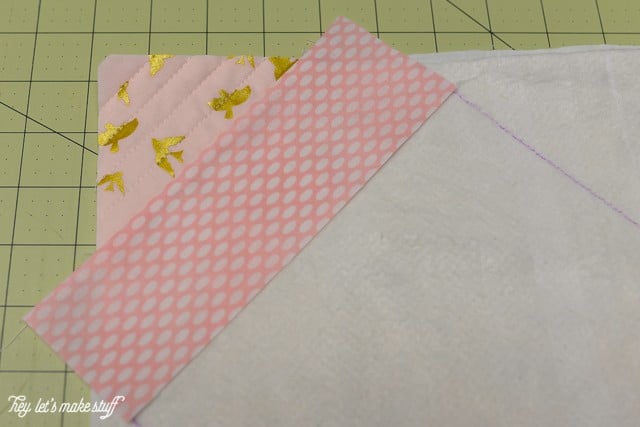 fabric corner and fabric strip on sewing mat and batting