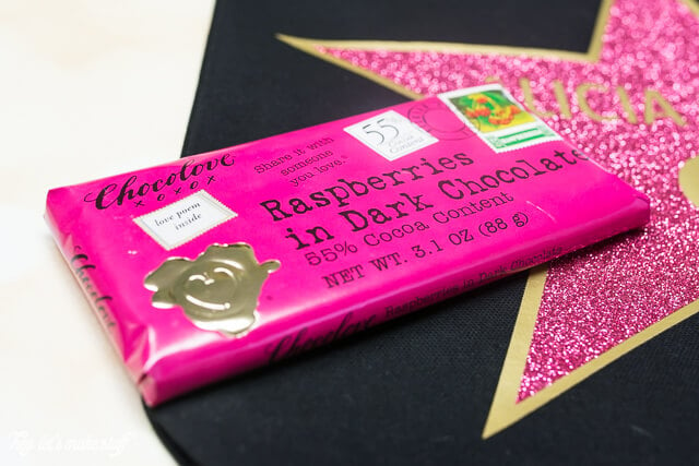 A close up of a candy bar wrapped in a hot pink wrapper