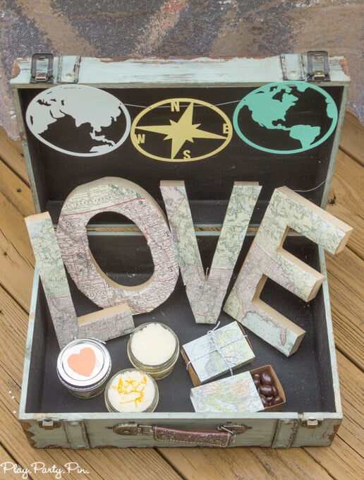 Around the World Pennants cut on a Cricut or Silhouette in globe and compass shapes in a chest box with love letters