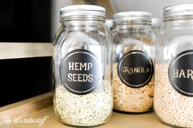A close up of bottles that have labels on them for Hemp Seeds, Granola and Barley