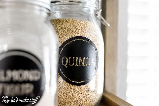 A close up of two jars on a shelf labeled with Almond Flour and Quinoa