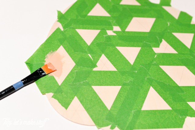 taped up grid lines to paint wooden pumpkin