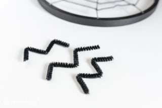 Turn some simple craft supplies into spooky Halloween spider hoops!