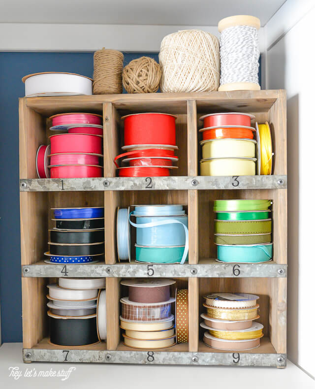 colored ribbon spools organized in craft room