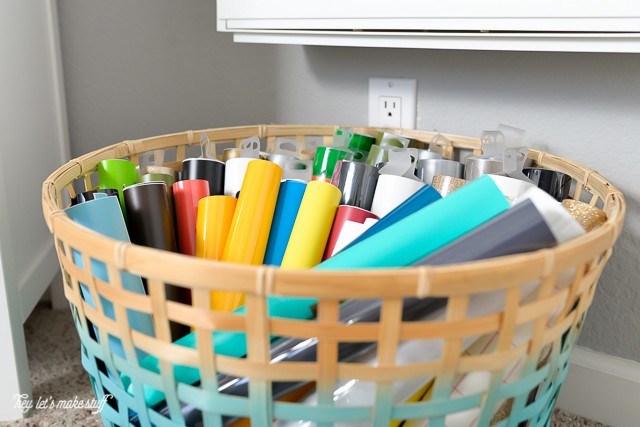 rolls of Cricut Vinyl in woven basket in craft room