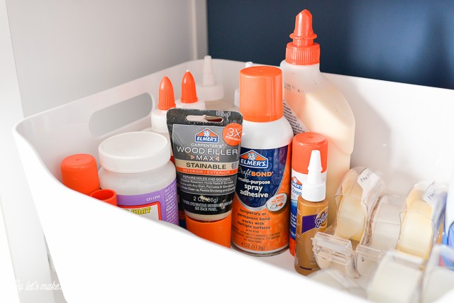 various craft glues organized in craft room