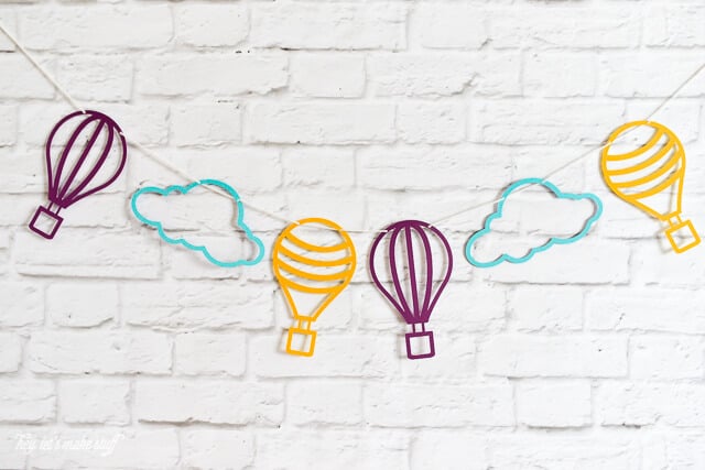 colorful hot air balloon and cloud SVG files cut on paper and strung against background
